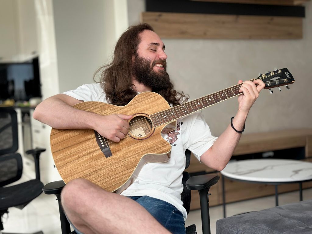Boryslav Linchevskyi playing guitar